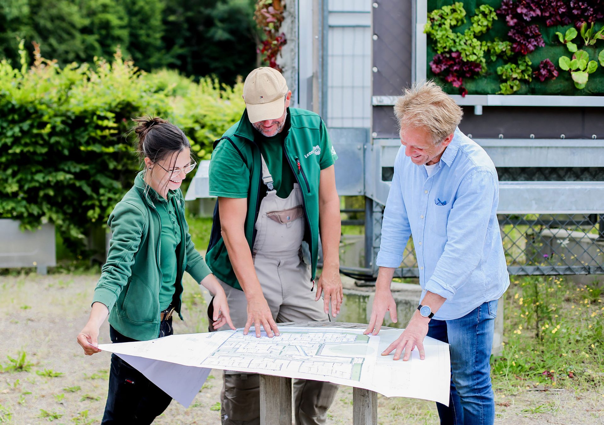 Landscaping team reviewing project plans together on site